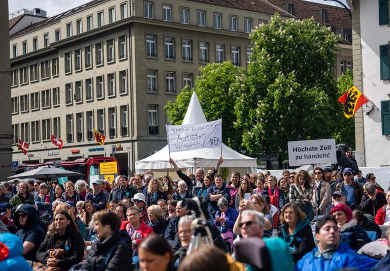 Publikum mit Plakaten auf dem Bundesplatz in Bern